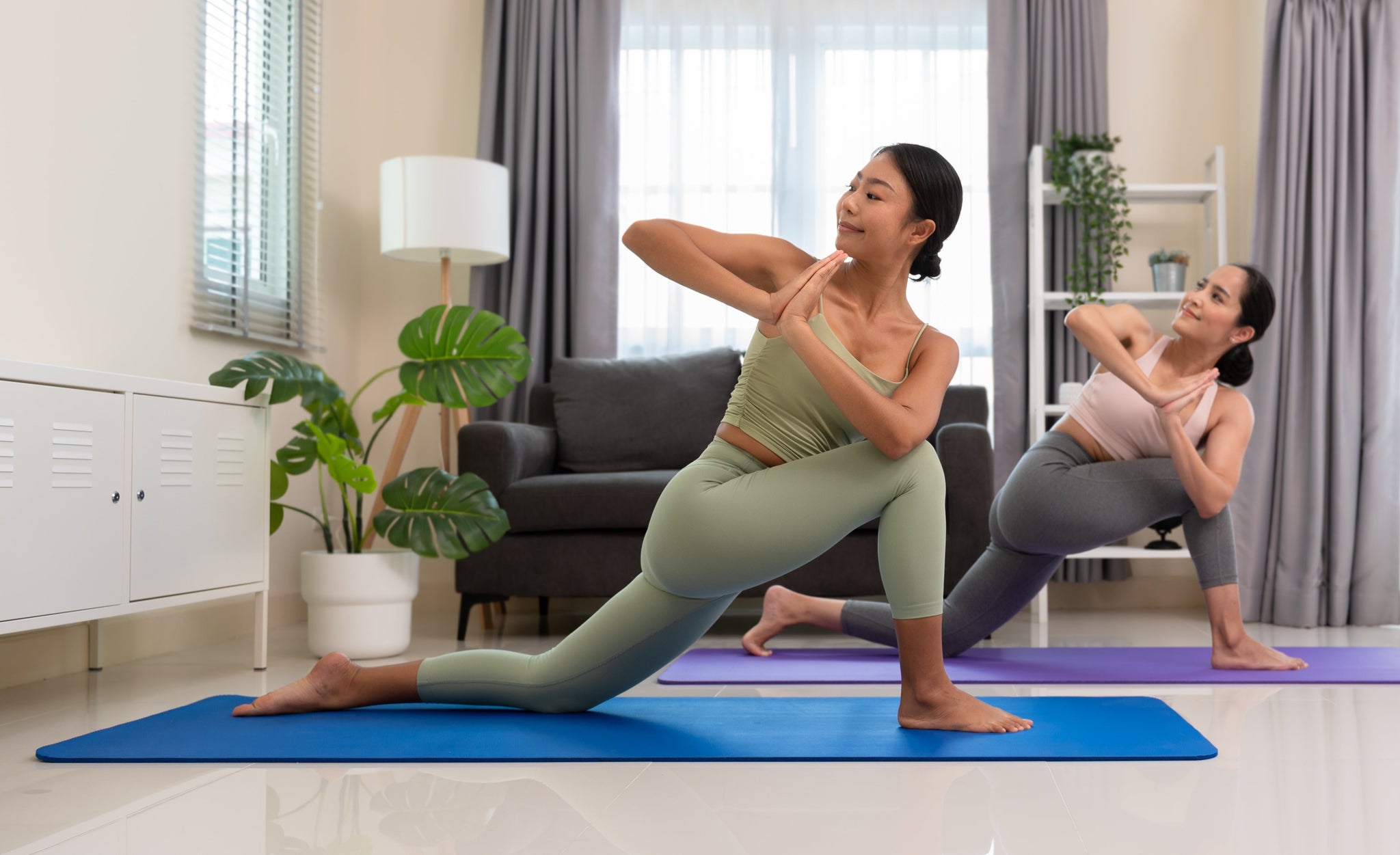 beautiful-two-healthy-women-revolved-low-lunge-pose-mat-while-doing-yoga-exercise-home