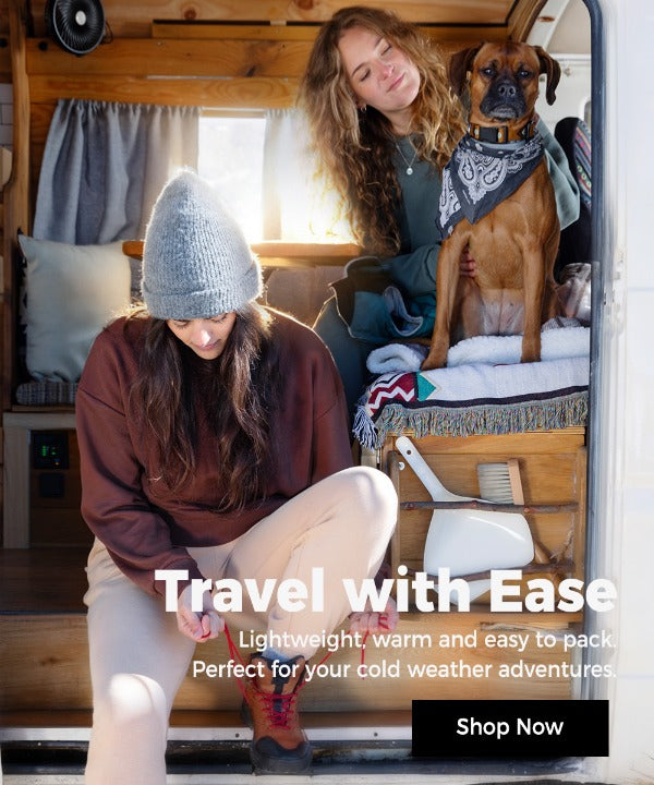 two women wearing cozy-fleece winter  clothing travel in a van with their puppy