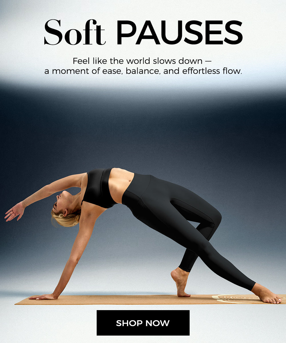 Woman wearing leggings in a yoga pose on a wooden platform
